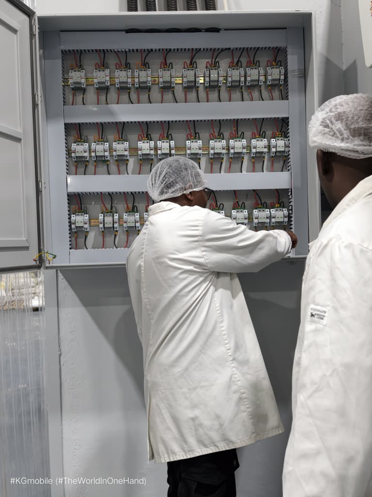 Technicians working on an electrical control panel